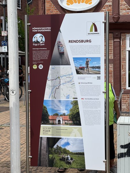 Informationsschild über den Ochsenweg in Rendsburg mit Bildern und Texten.